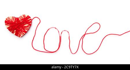 Hearth and word Love made with red thread isolated on white background Stock Photo