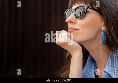 A large portrait of a girl in the city. Beautiful girl with glasses Stock Photo