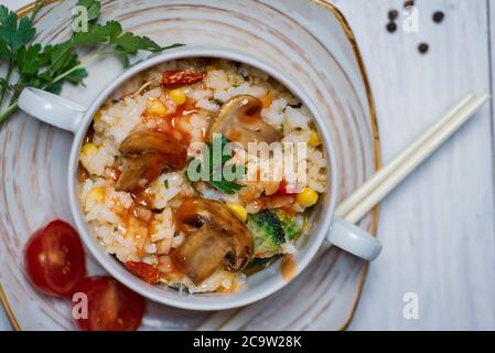 Homemade vegetarian risotto with mushrooms and vegetables on a plate Stock Photo