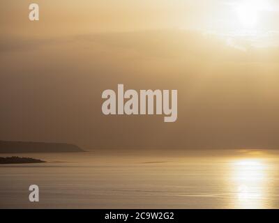 The warm glow over the sea near the fishing town of Scilla in Italy. Stock Photo