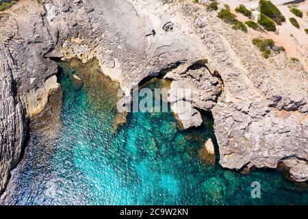 Aerial view of villas residences on cliffs and clear blue green water bay Cala Marmassen Mallorca Spain. Stock Photo