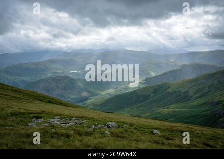 Shafts of sunlight on Easdale and Grasmere Common from the summit of Helvellyn, Lake District, UK Stock Photo
