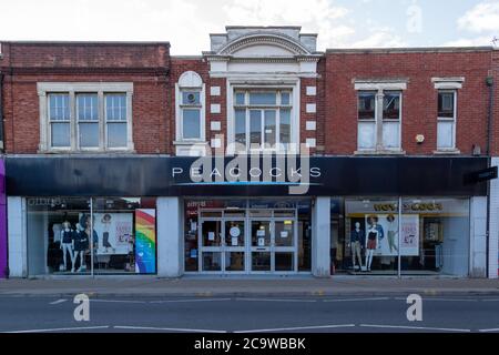 The exterior of a closed Peacocks clothes store, an english high street shop Stock Photo