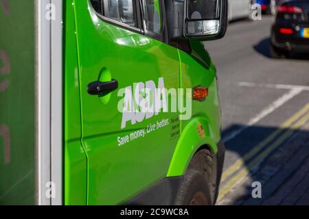 The ASDA supermarket logo on the side of an ASDA delivery van used for home grocery deliveries Stock Photo