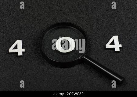 Numerals 404 and magnifying glass on black background. Error concept Stock Photo