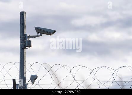 Surveillance Camera and barbed wire, border, prison, concept picture Stock Photo
