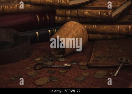 Antique still life composition with coins, keys and books Stock Photo