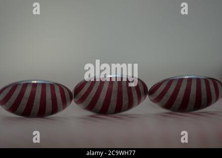 Three spoons composed to reflect red vertical lines Stock Photo