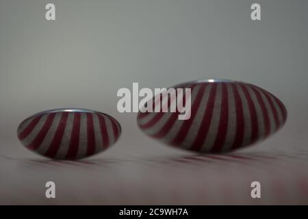 Two spoons composed to reflect red vertical lines Stock Photo