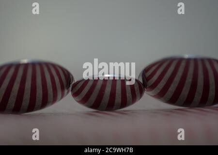 Three spoons composed to reflect red vertical lines Stock Photo