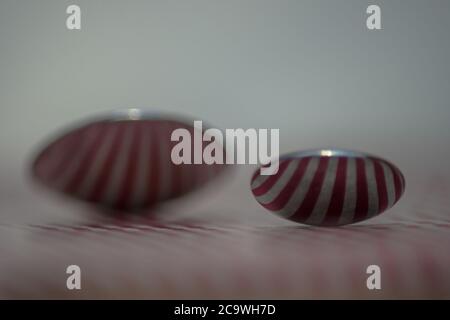 Two spoons composed to reflect red vertical lines Stock Photo