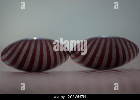 Two spoons composed to reflect red vertical lines Stock Photo