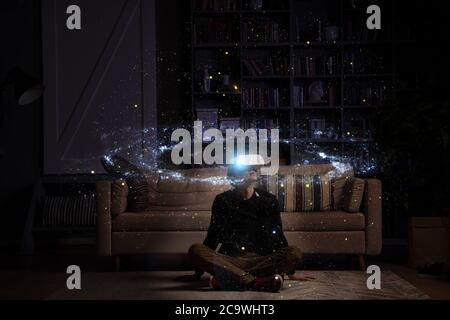 Man uses virtual reality glasses to see the galaxy space. Elements of this image furnished by NASA. Stock Photo