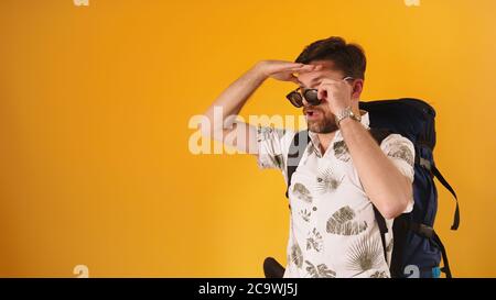 Bearded Caucasian man in 30s looking for the direction with removed sunglasses. High quality photo Stock Photo