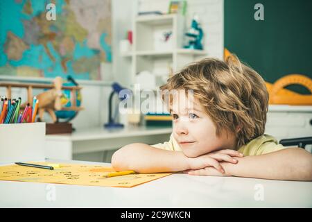 Cute face of pupil, close up. Talented child. Kid gets ready for school. Cute pupil with funny face schooling work. Stock Photo