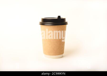 Eco friendly paper craft cup for coffee with black lid on the white background. Zero waste, plastic free concept. Sustainable lifestyle. Front view. Stock Photo