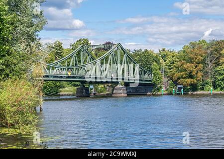 Potsdam, Germany -  July 12, 2020: Western (Berlin) part of the Glienicke Bridge, the famous Bridge of Spies, seen from the shore of the Tiefer See (T Stock Photo