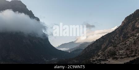 Panorama of mountains surrounding Upper Pisang, over Marshyangdi river, Annapurna circuit, Nepal Stock Photo