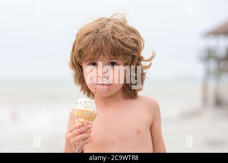 Funy curly child with icecream outdoor. Stock Photo