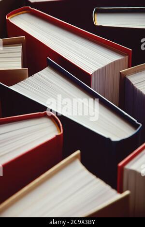 many hardcover books standing as background, vertical photograph Stock Photo