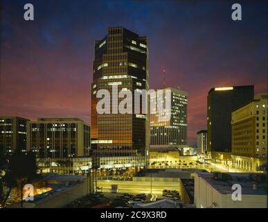 Pima County  AZ/ DEC Dusk over the illuminated buildings of downtown Tucson looking north with Broadway Blvd in foreground. Stock Photo