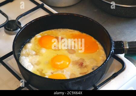 Eggs are fried in a pan. Cooking fried egg Stock Photo