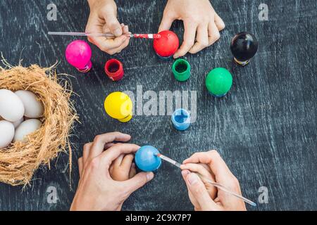 Happy easter A mother, father and their son painting Easter eggs. Happy family preparing for Easter Stock Photo