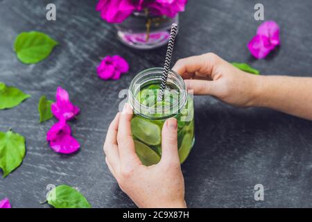 Spring purple flowers and spring mojito drink on an old wooden background Stock Photo