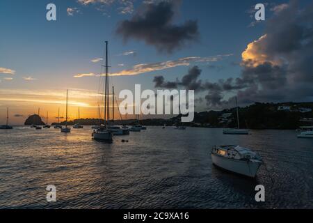 Saint Vincent and the Grenadines, sailboats mooring in Blue Lagoon and sunset Stock Photo
