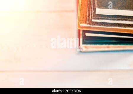 Stack of old used books on white wooden background. Pile of vintage old hardback books. Back to school. Copy space Stock Photo