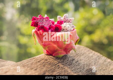 Pieces of sliced dragon fruit in the form of a star on an old withered background Stock Photo