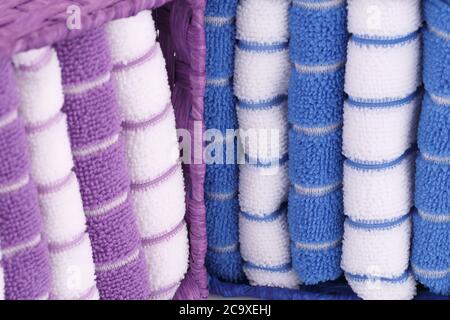Pink, blue and white folded towels in boxes closeup picture. Stock Photo