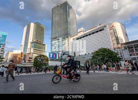 An Uber Eats delivery man rides his rental bicycle through a 