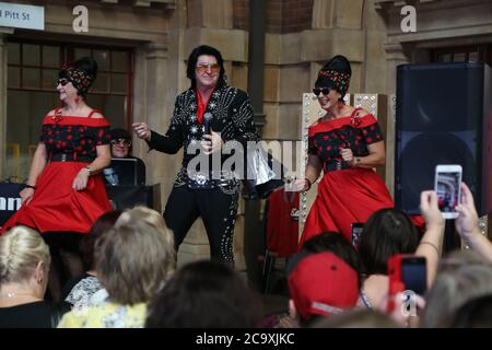 An Elvis impersonator entertains the crowds at Central Station in Sydney before the departure of the NSW Trainlink Elvis Express train to Parkes. Stock Photo