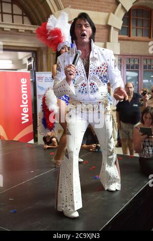 An Elvis impersonator entertains the crowds at Central Station in Sydney before the departure of the NSW Trainlink Elvis Express train to Parkes. Stock Photo