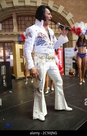 An Elvis impersonator entertains the crowds at Central Station in Sydney before the departure of the NSW Trainlink Elvis Express train to Parkes. Stock Photo