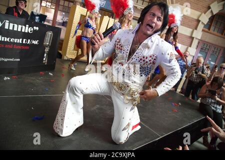 An Elvis impersonator entertains the crowds at Central Station in Sydney before the departure of the NSW Trainlink Elvis Express train to Parkes. Stock Photo