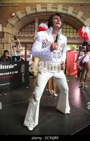 An Elvis impersonator entertains the crowds at Central Station in Sydney before the departure of the NSW Trainlink Elvis Express train to Parkes. Stock Photo