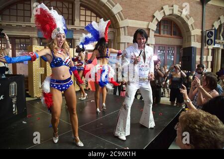 An Elvis impersonator entertains the crowds at Central Station in Sydney before the departure of the NSW Trainlink Elvis Express train to Parkes. Stock Photo