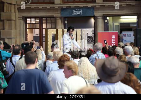 An Elvis impersonator entertains the crowds at Central Station in Sydney before the departure of the NSW Trainlink Elvis Express train to Parkes. Stock Photo