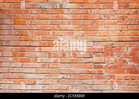 red wall of worn dirty broken bricks Stock Photo