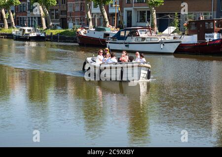 Lokeren, Belgium, July 13, 2020, Motor boat with eight people sails on the Durme in the center of Lokeren Stock Photo