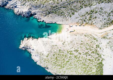 Coastline on Adriatic sea in Croatia, beautiful secret beach among stone cliffs near town of Vrsi, aerial overhead view Stock Photo