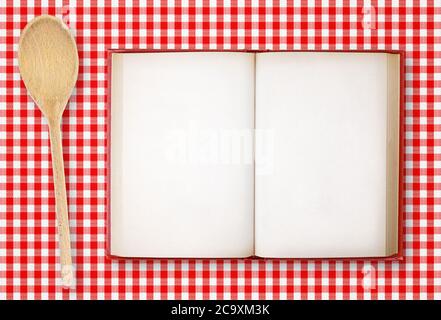 Top view of open old recipe book on red tablecloth Stock Photo