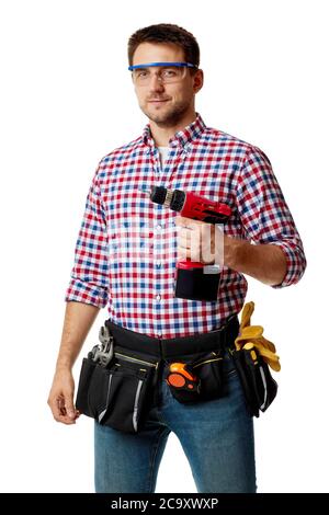 caucasian repairman worker holding cordless screwdriver. handyman wearing tool belt isolated on white studio background Stock Photo