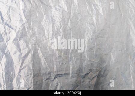 Beautiful closeup background with gray crumpled raincoat fabric. Ideal for use in the design or wallpaper Stock Photo