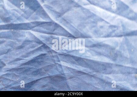 Beautiful closeup background with dark gray crumpled raincoat fabric. Ideal for use in the design or wallpaper Stock Photo