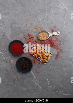 mixed nuts with raw ingredients and spices Stock Photo