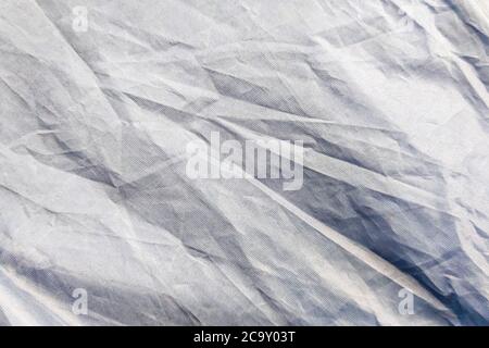Beautiful closeup background with gray crumpled raincoat fabric. Ideal for use in the design or wallpaper Stock Photo