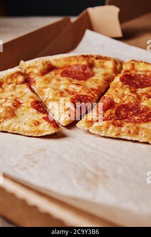 Slice of pizza in cardboard box, close up Stock Photo